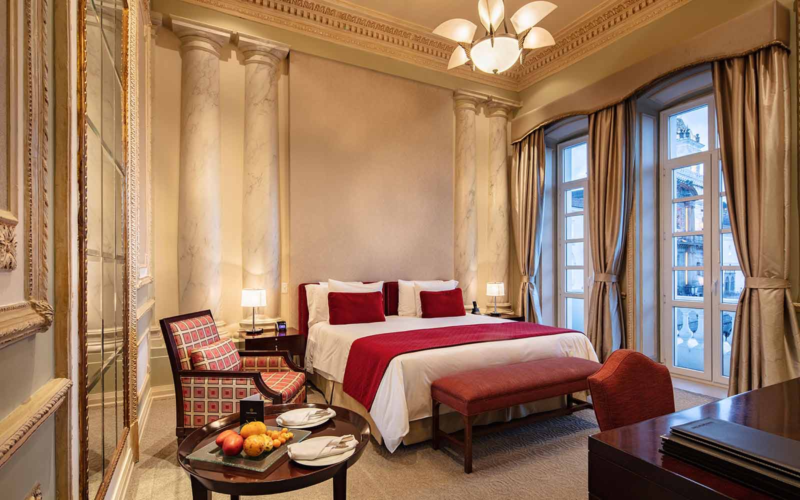 A hotel room with a large bed and a large window.