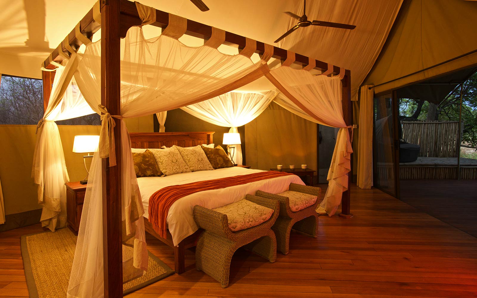 A bed in a tent with a canopy.