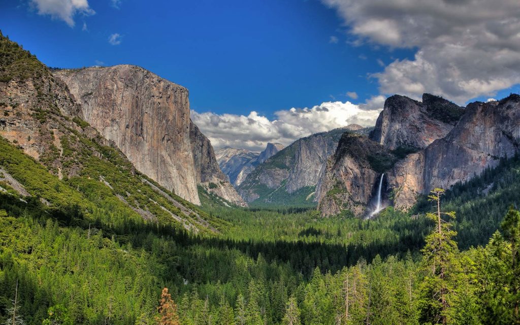 Yosemite Valley with blue sky, clouds and waterfall