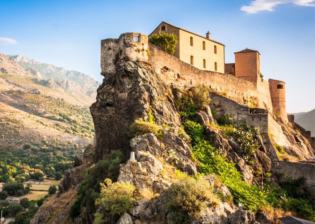 A picturesque castle majestically perched atop a breathtaking mountain. It is nestled amidst one of the most beautiful villages in Europe.