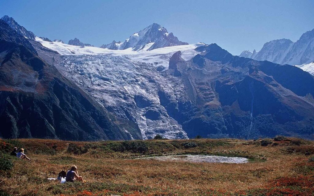 Hikers resting and taking in landscape views of the Alps Mountains in France.