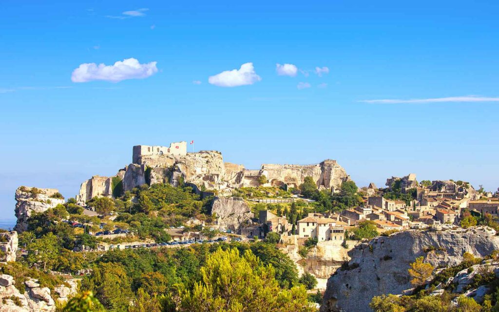 Landscape view of Marquis de Sade castle and medieval village while hiking in Provence, France.
