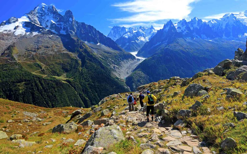 A group of people hiking up a rocky path in the mountains on Patagonia hiking tours.
