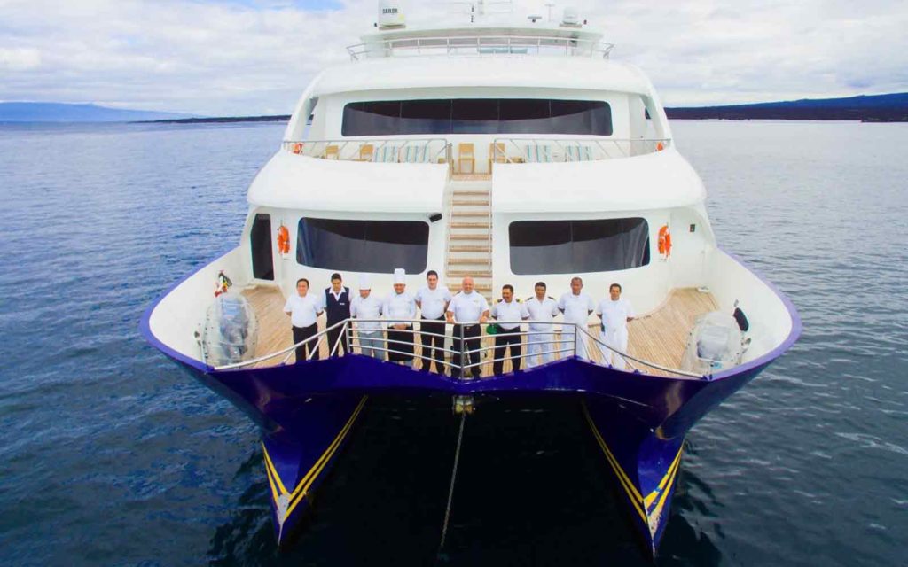 Join an exciting group of people on an Adventure Cruise as they stand at the front of a boat, ready to embark on a thrilling journey.