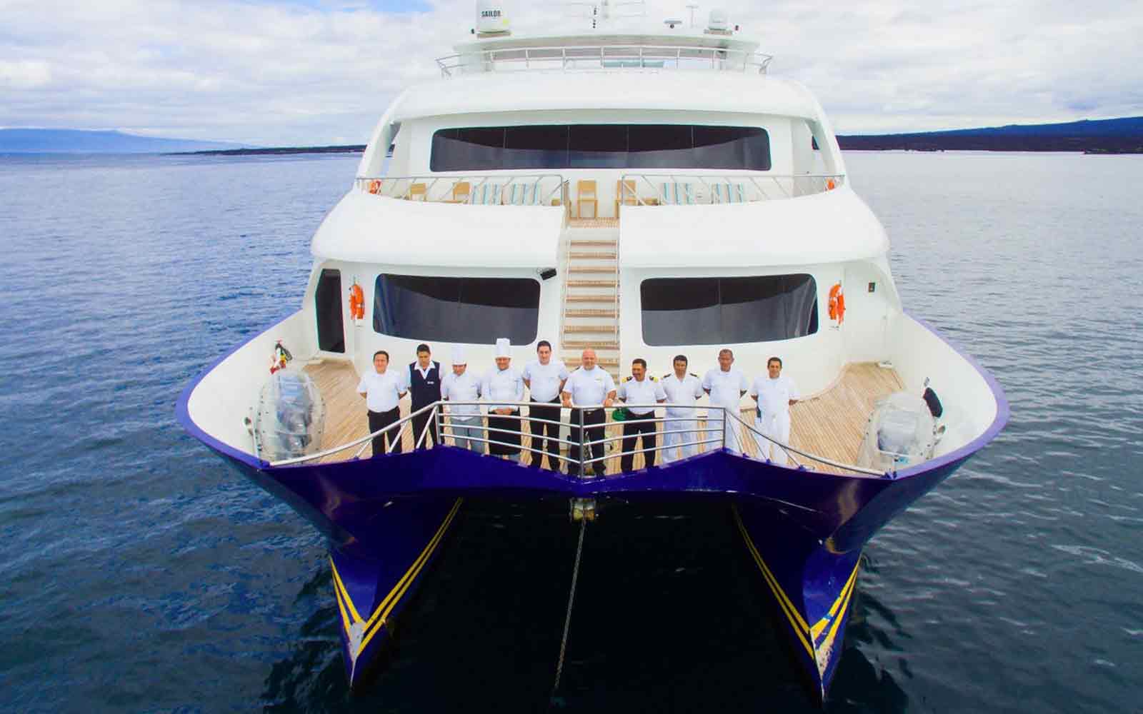 Join an exciting group of people on an Adventure Cruise as they stand at the front of a boat, ready to embark on a thrilling journey.