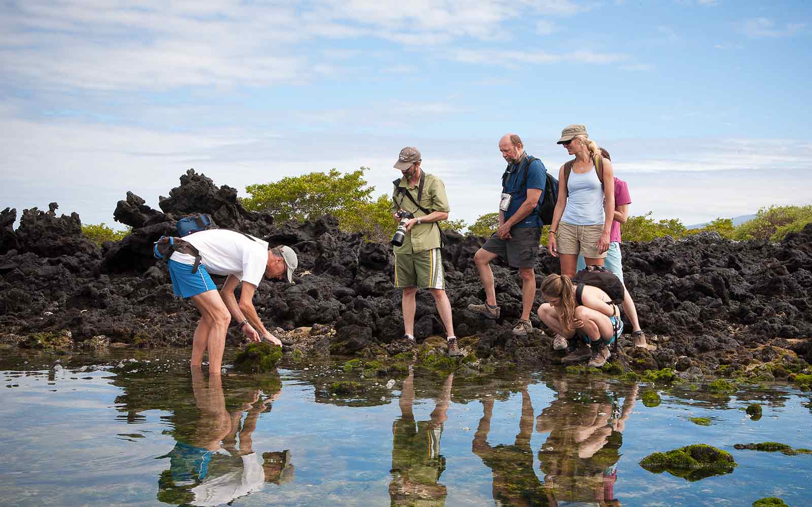 Adventure Cruise passengers observing rocks in the water.