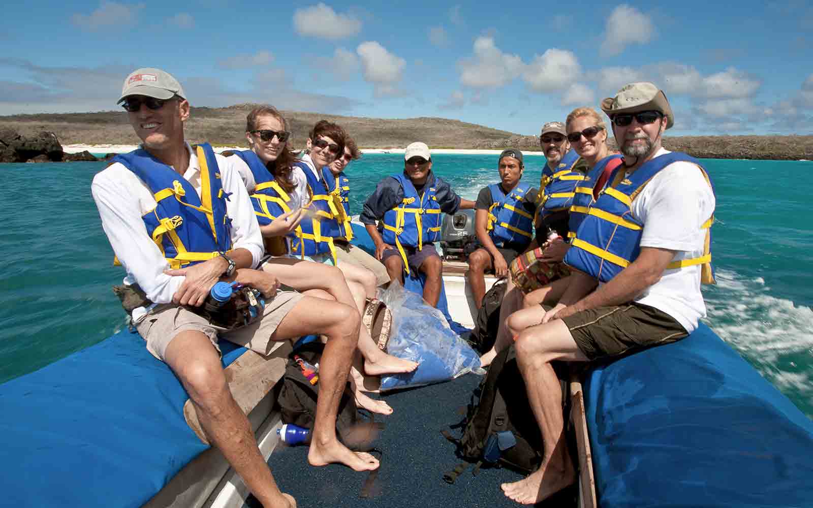 A group of people on a boat in the ocean.