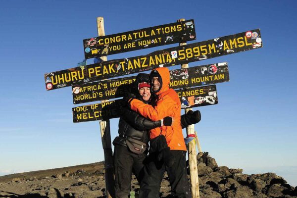 Two people hugging at the top of a mountain during an Africa Adventure Travel