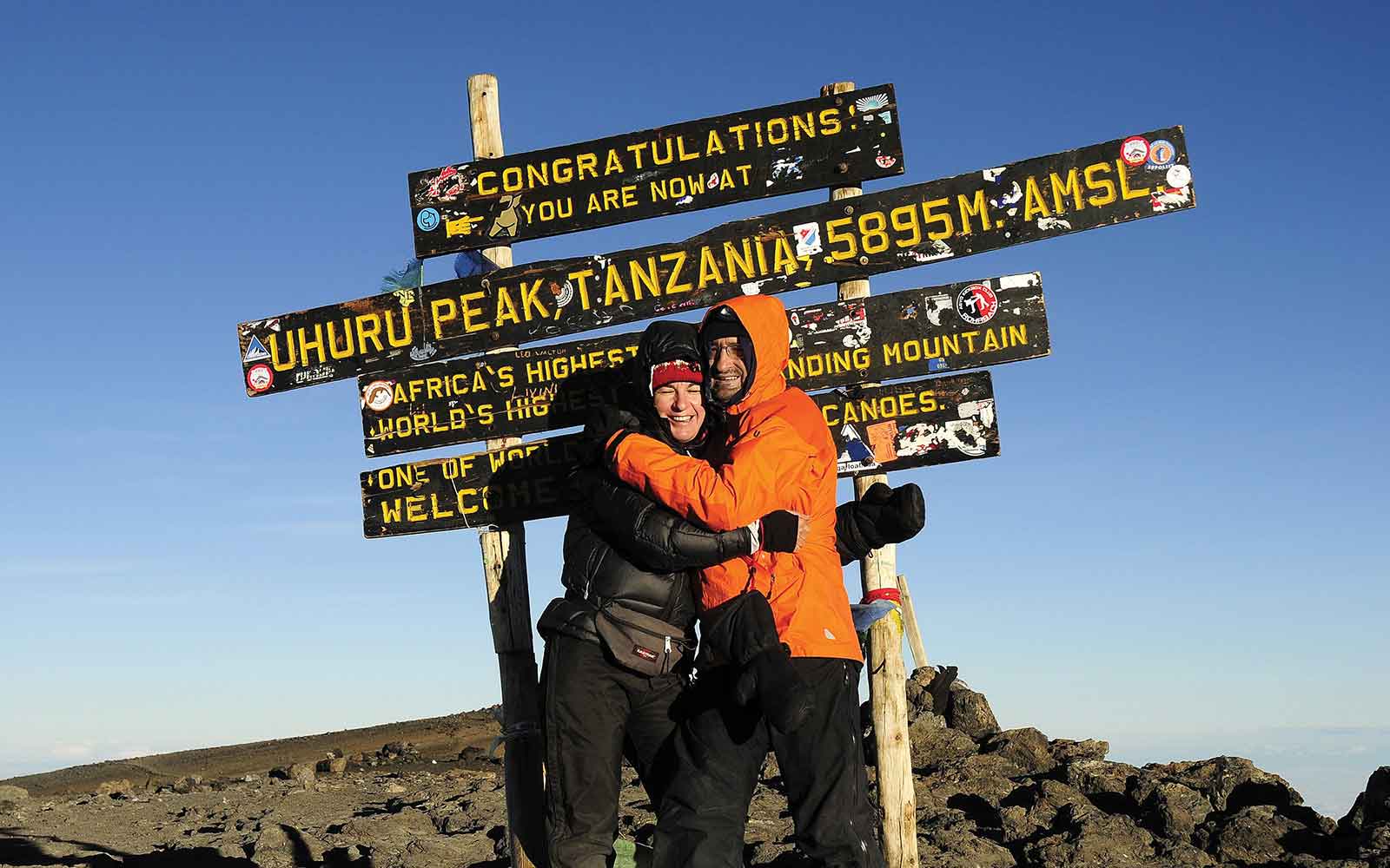 Two people hugging at the top of a mountain during an Africa Adventure Travel