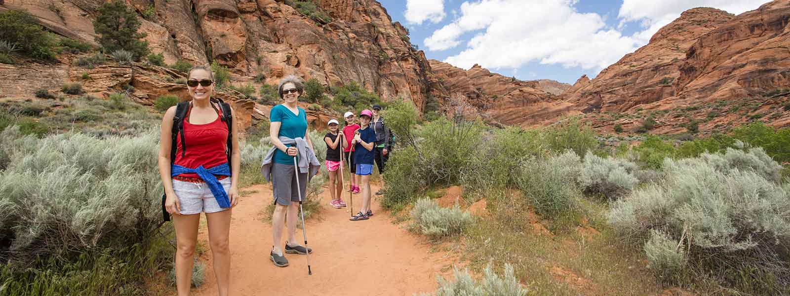 A family of hikers on an adventurous trail in Zion National Park.