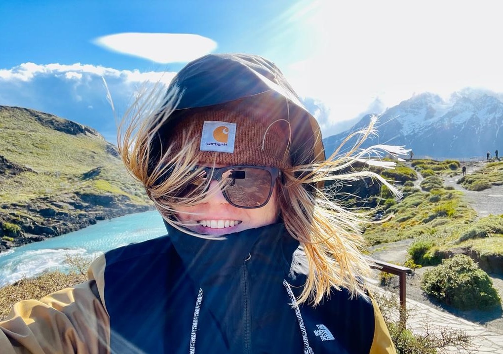 girl in a beanie is in front of Patagonia mountain views