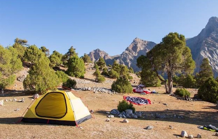Hikers camping on a trail in Tajikistan Fann Mountains