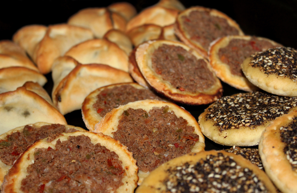 An assortment of Lebanese baked food, spinach pies, Man'oushe with zaatar, and minced meat small pizzas An assortment of Lebanese baked food, spinach pies, Man'oushe with zaatar, and minced meat small pizzas