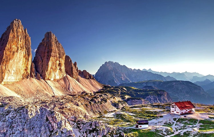 A village with the backdrop of Dolomites A village with the backdrop of Dolomites