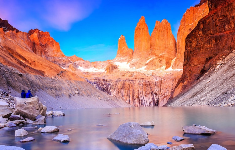 two friends hikers sitting on rock overlooking scenery in Patagonia W Route trail