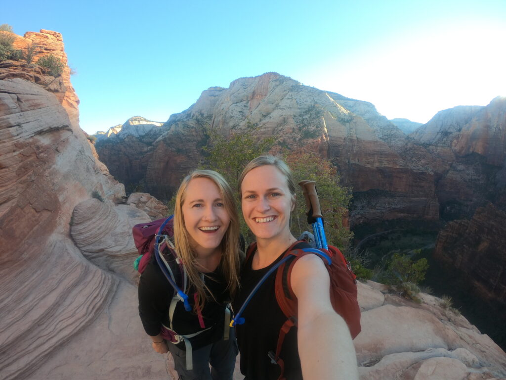 two travelers enjoying the Navajo sandstone at Zion National Park in Angel's Landing