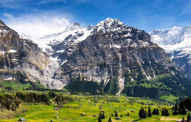 Hikers in a village to village trail adventure in the Alps in Europe