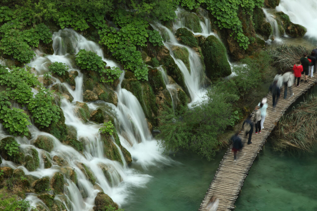 Cascading waterfalls spilling into lake in plitvice lakes national park