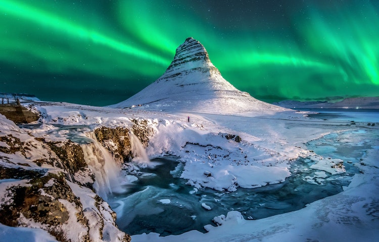 Tourists glimpsing the Aurora Northern Lights in Iceland in the wintertime