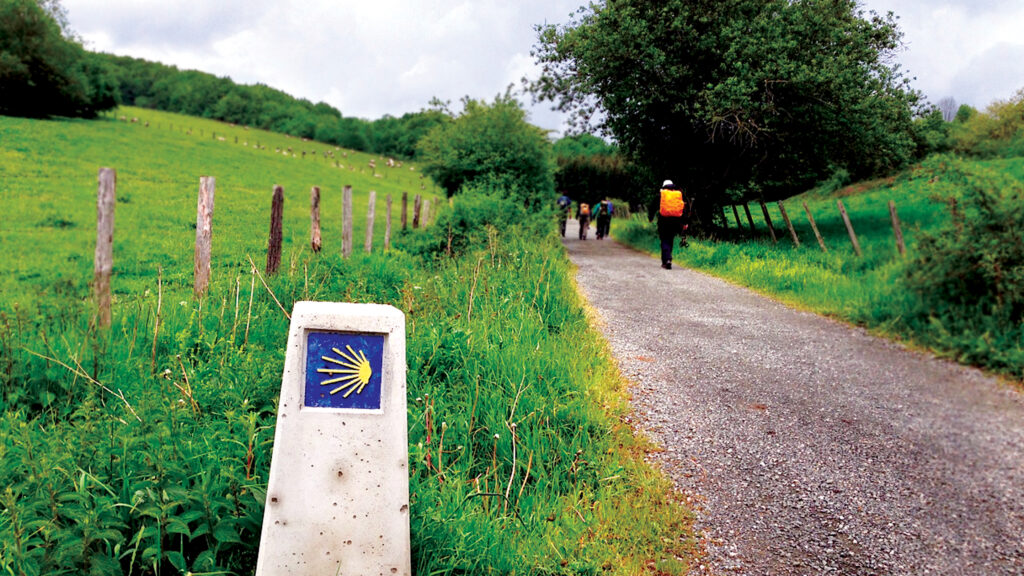Tourists walking the legendary Camino de Santiago trail on a pilgrimage