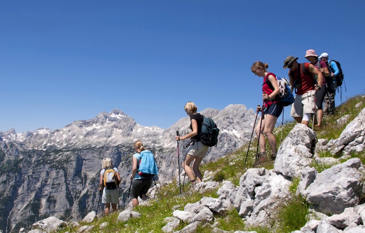 Hikers with hiking poles trekking on a Slovenia guided tour 