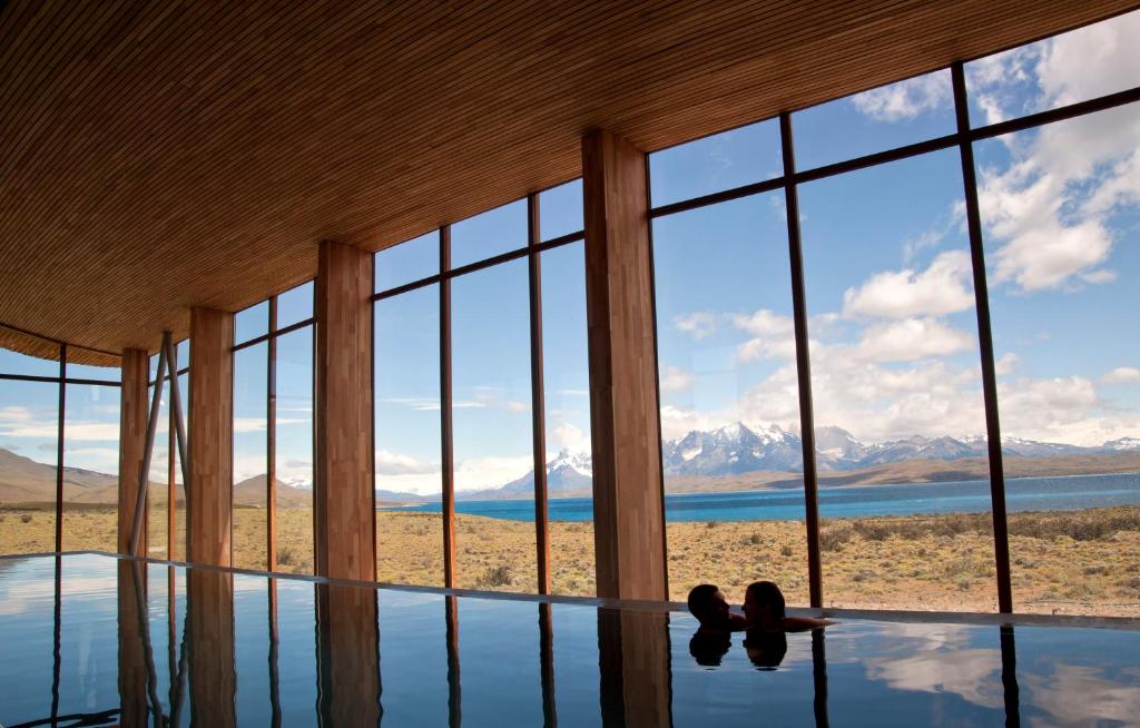 A couple looking at each other earnestly in the indoor pool in Tierra Patagonia Hotel & Spa in Torres del Paine National Park in Chile