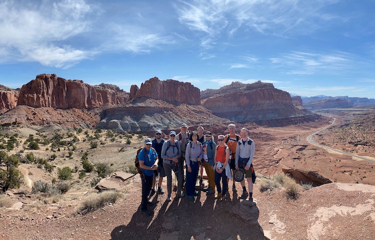 A group of people posing for a picture in a Utah canyon.