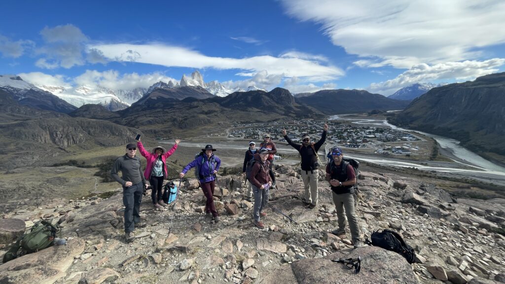 Small group of elderly travelers hiking on a trail in Patagonia