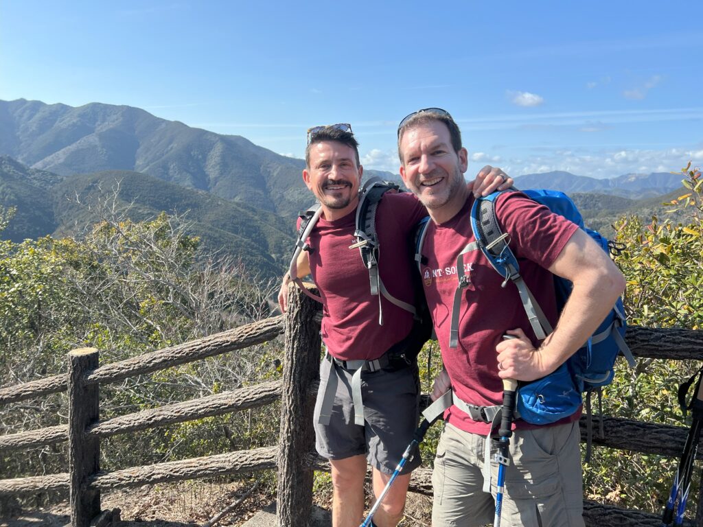 Couple with MT Sobek gear posing with a magnificient backdrop of the Kii Mountain Range along the Kumano Kodo Pilgrimage Route in Japan