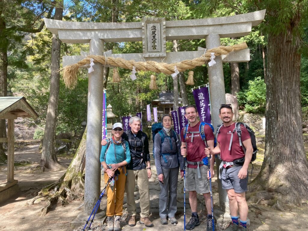 Group of travelers stopping at one of the five major Oji shrines on the Kumano Kodo route in Japan