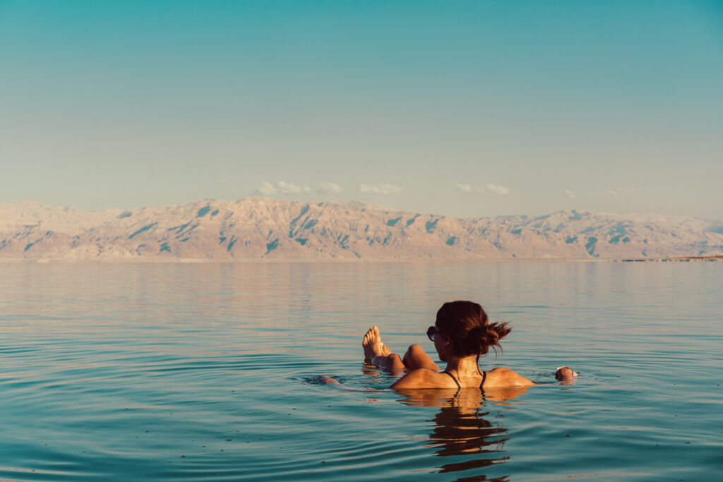 Woman is floating in the Dead Sea in Israel during her  stay