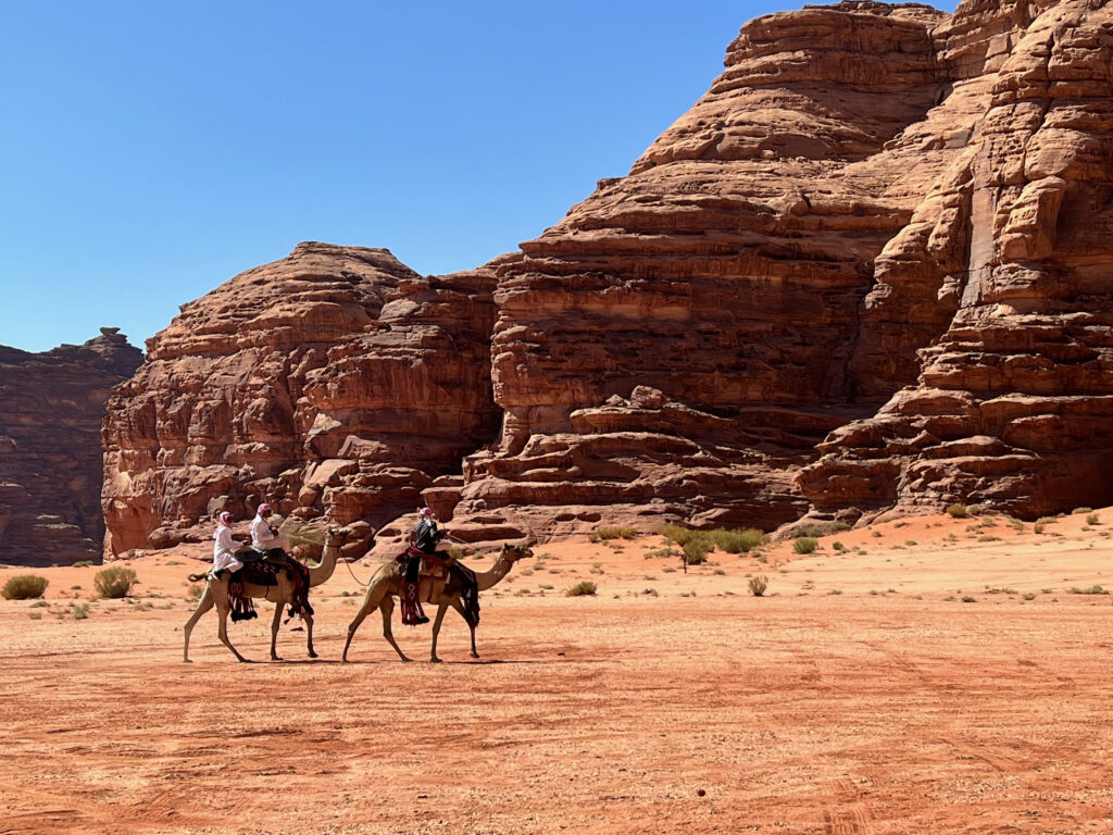 Tourists riding camels in the dessert landscapes of Saudi Arabia