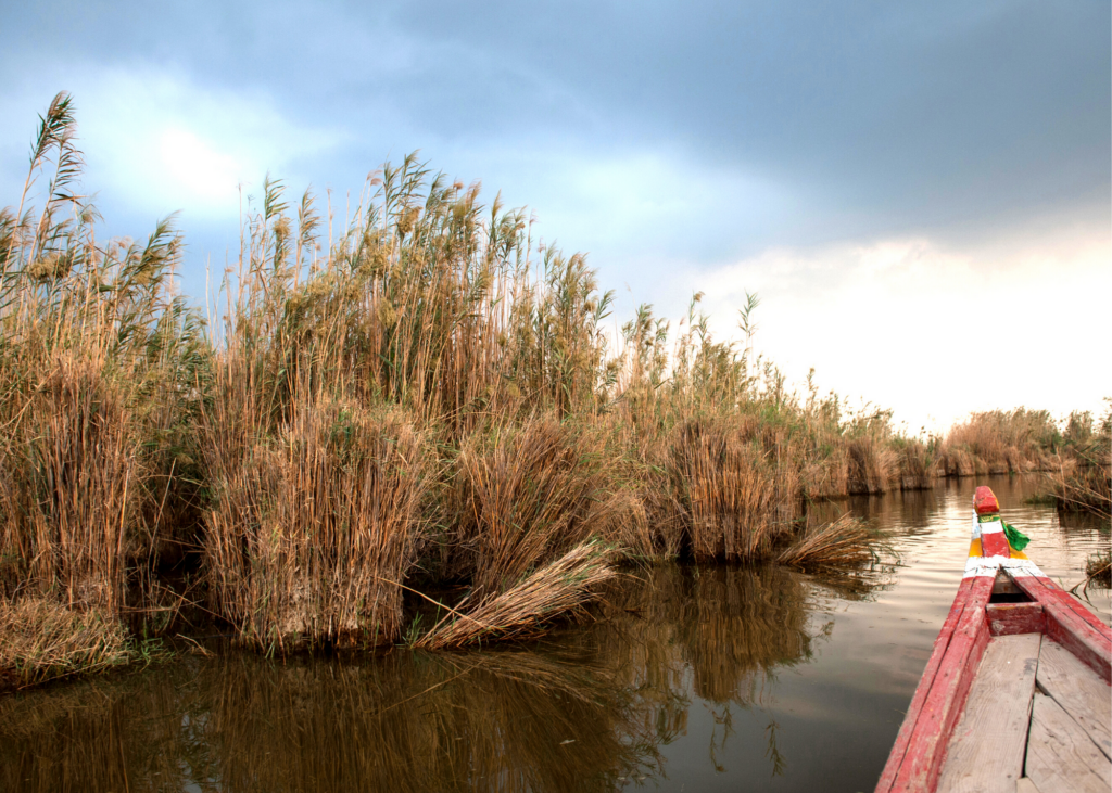Travelers on a traditional boat floating near the Euphrates and Tigris Rivers in Iraq