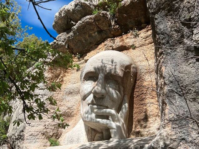 Tourists look at the historic statue of Lebanese poet Mikhail Naimy in the Baskinta Literary Trail