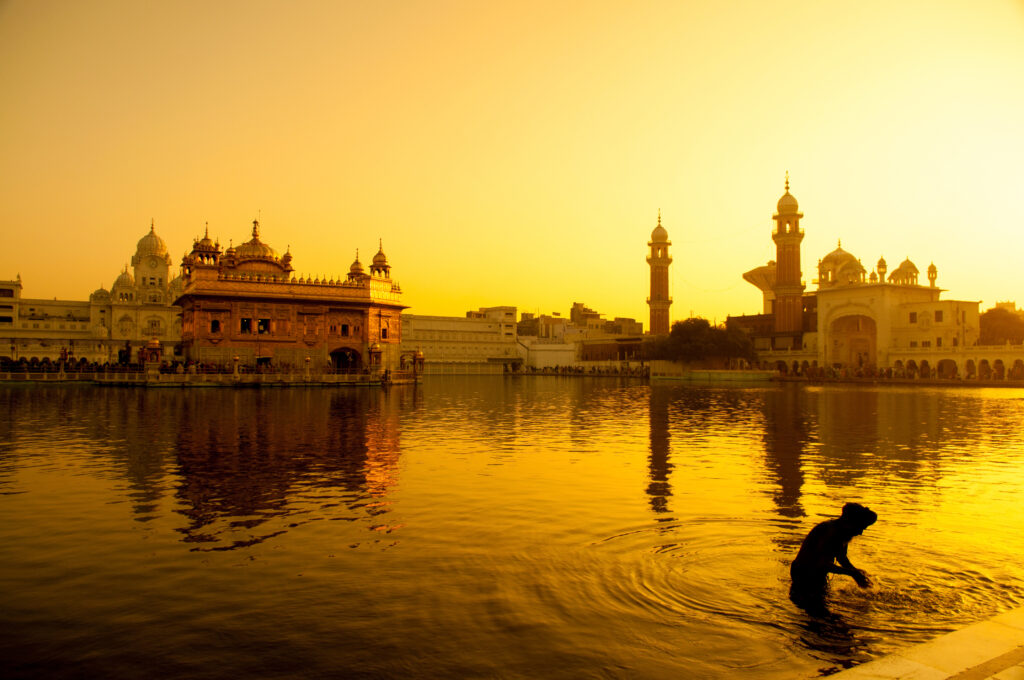 Sunset coloring the Golden Sahib Temple in Amritsar Spiritual Center in Punjab, India, Asia