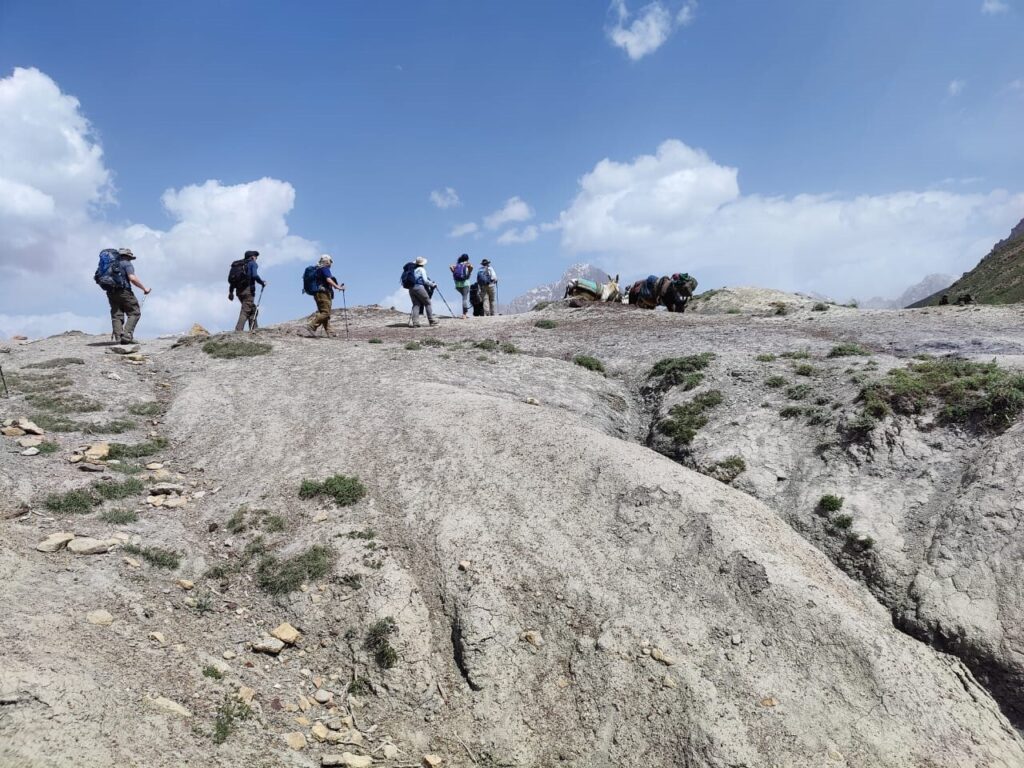 Group of hikers trekking the great Alauddin Pass in Tajikistann Fann Mountains