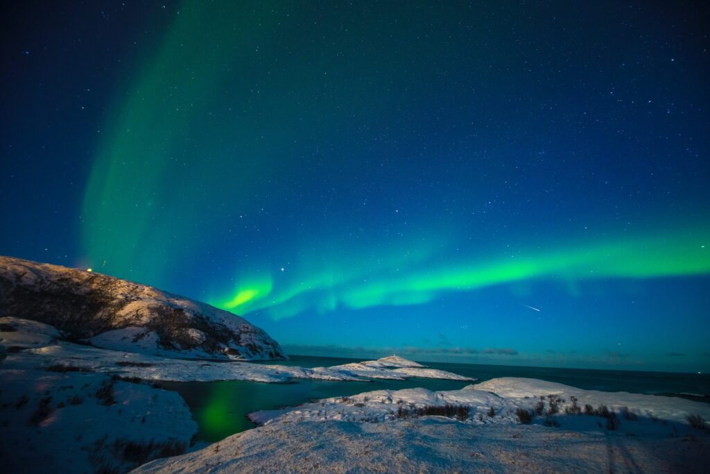 Breathtaking capture of the beautiful Aurora Borealis at Tromso, Norway. And with heavens help, manage to capture a streaking shooting star across the starry skies.

