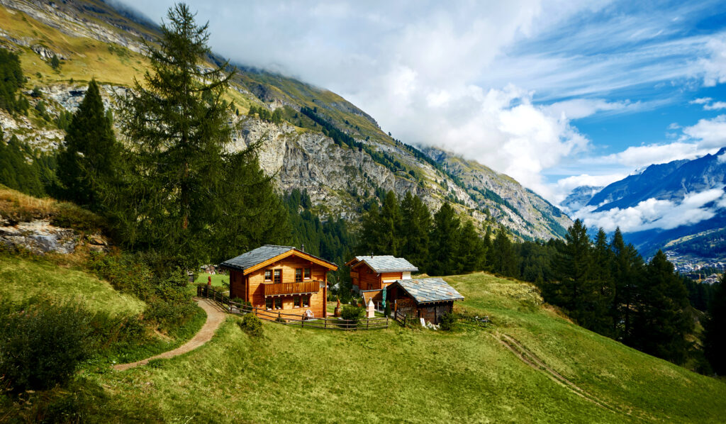 Alpine meadow with houses at afternoon, around Zermatt
