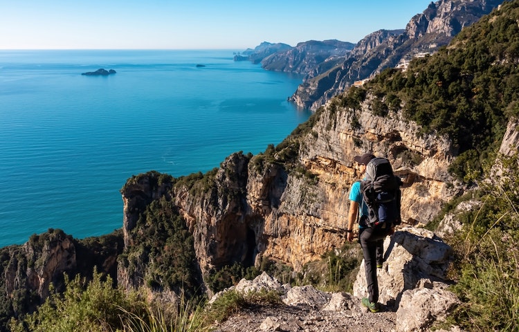 Hiker looking out over the sorrento peninsula and amalfi coast