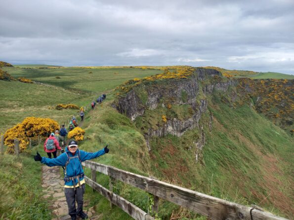Excited hiker on famous North to South Hiking Trail in Ireland in Europe