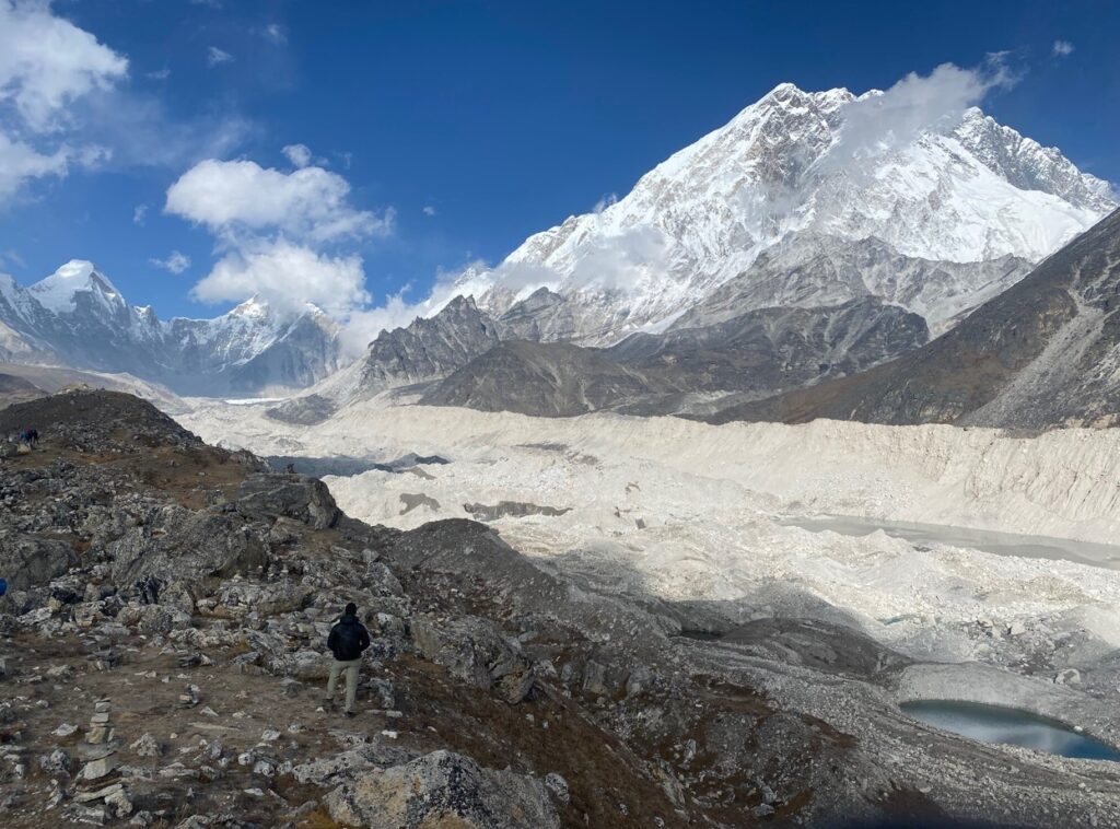 group of hikers on a himalayan hiking trail adventure stops at Khumbu Glacier
