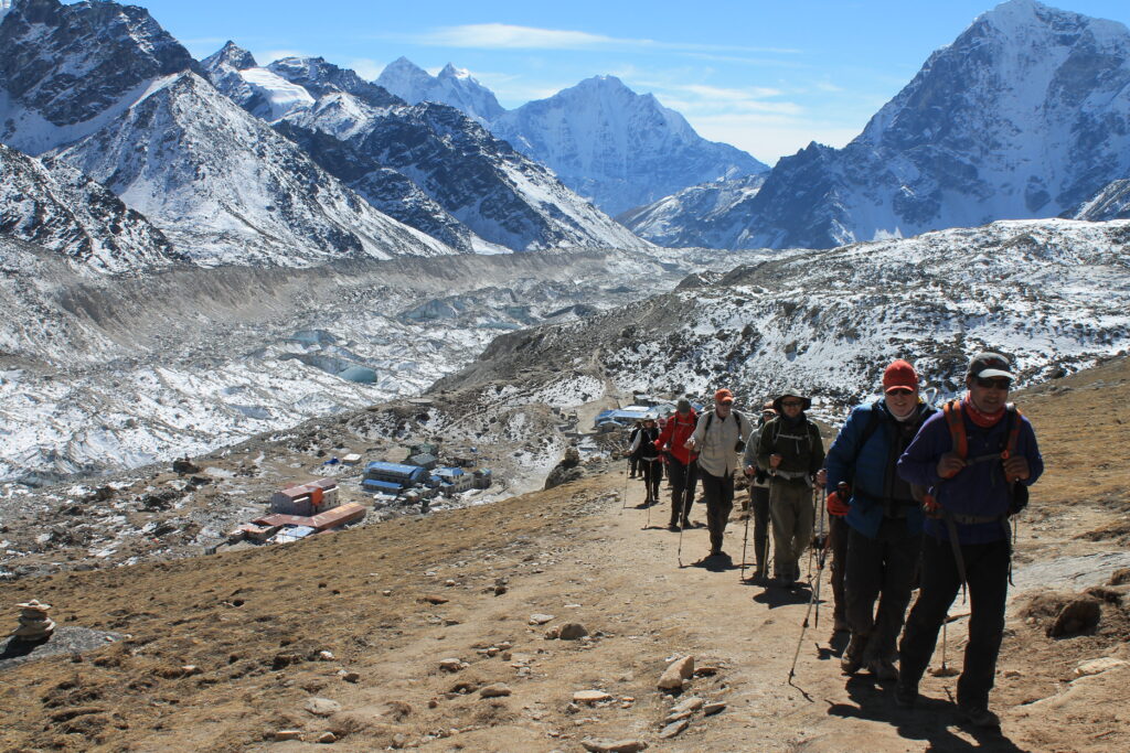 group of hikers guy and girl on a guided trek en route to Everest Base Camp in Nepal 