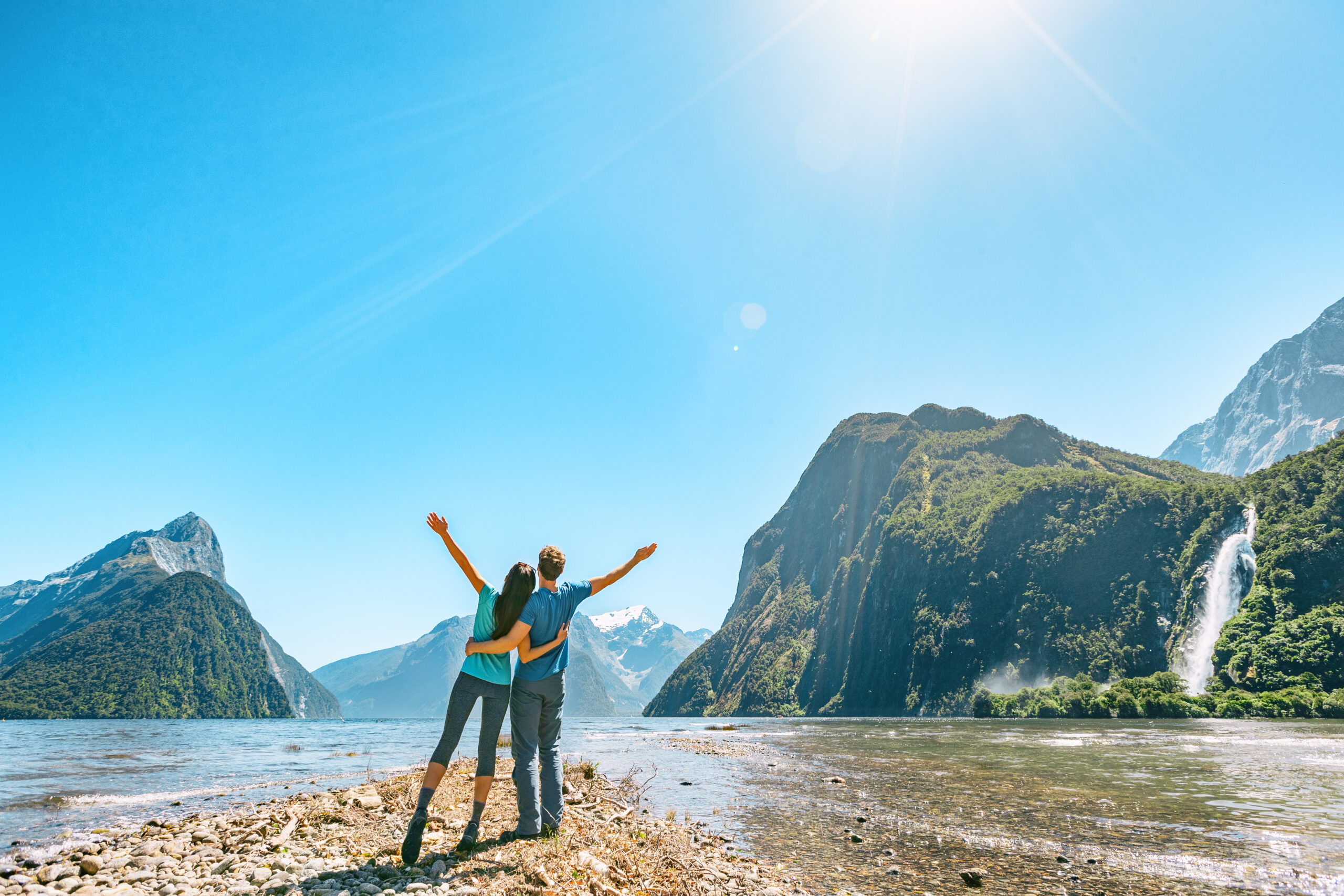 a couple female and male enjoying lakeside views of Fiordland in South Island of New Zealand, Europe