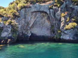 Admiring Maori rock carvings on rock wall in Lake Taupo in New Zealand North Island, Europe