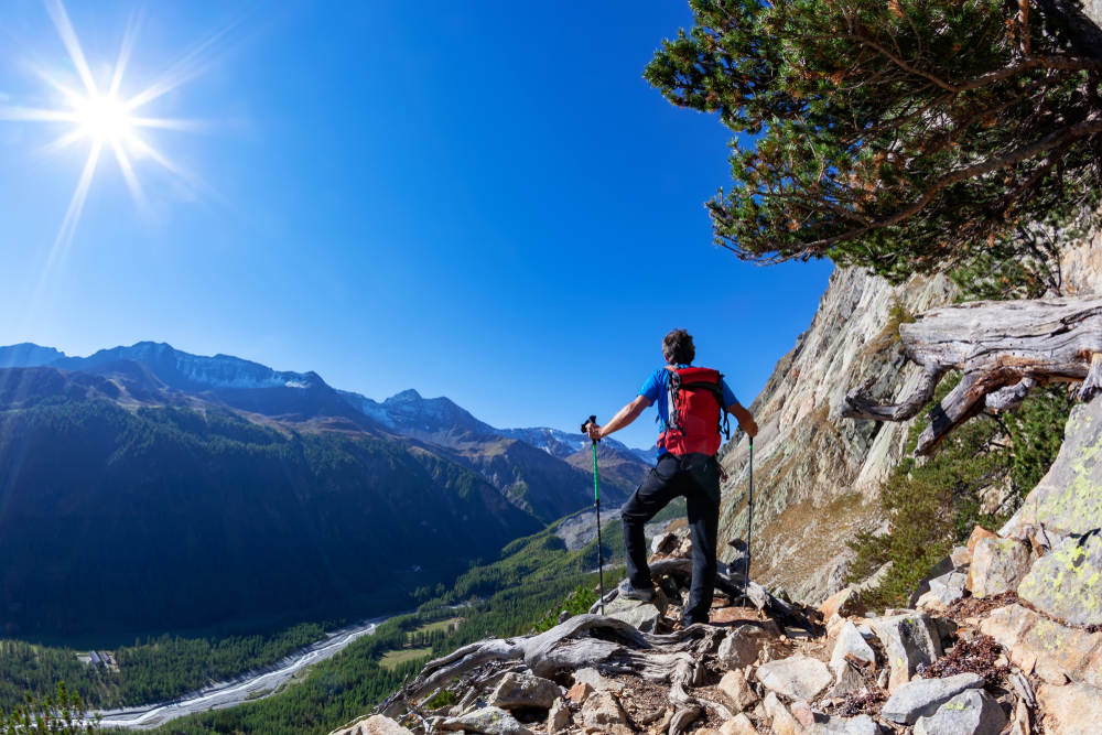 tall solo male traveler embarking on challenging trek that traverses the Graian Alps, a crossroads between Italy and France in Gran Paradiso National Park in Europe