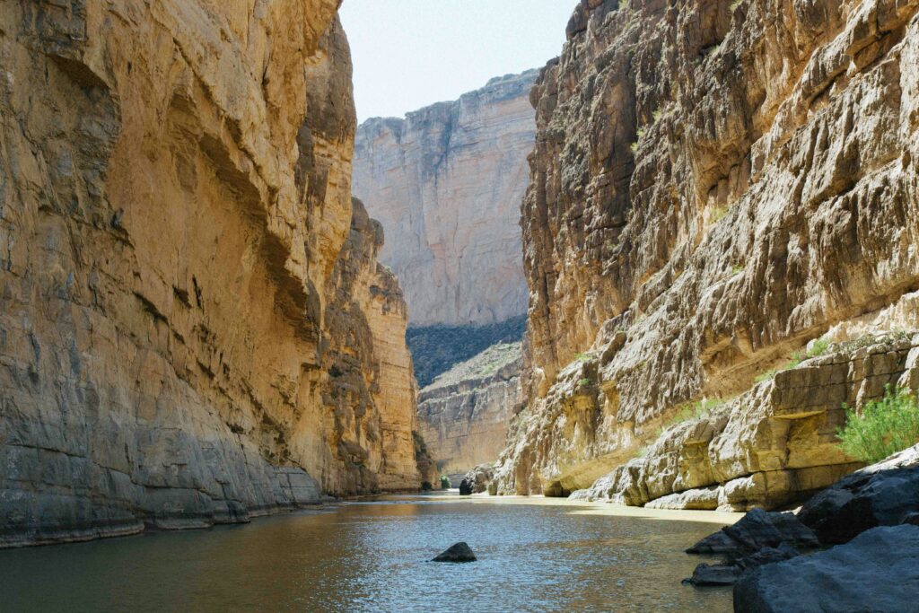 river between rocky mountains under clear sky in Santa Elena Canyon hiking trail in Big Bend National Park