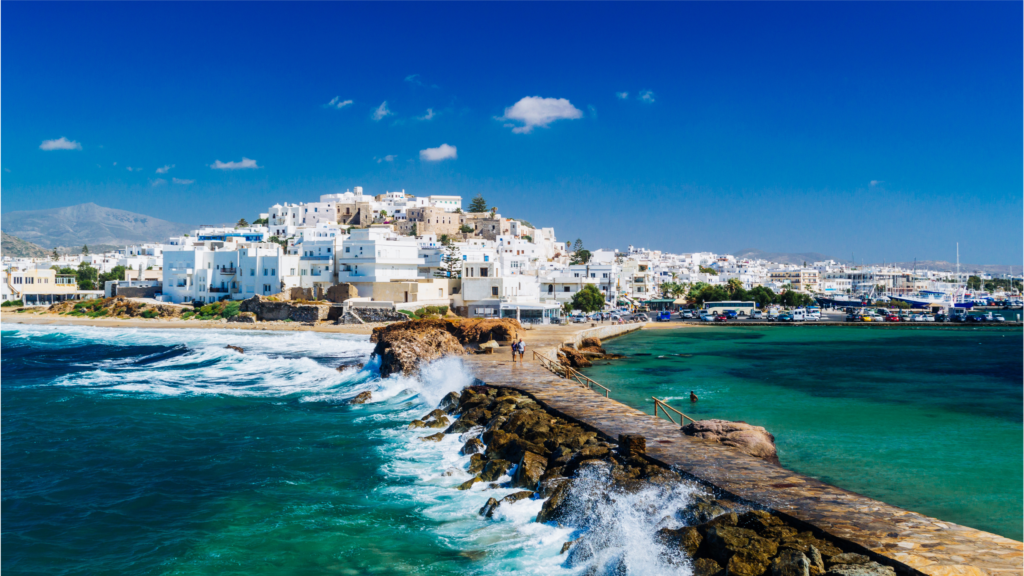 green and blue waves crashing against Naxos islands in the summertime in Greece, Europe