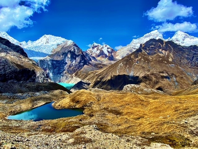 solo hiker trekking a hiking trail along Cordillera Blanca on high altitude trek in Peru, Latin America