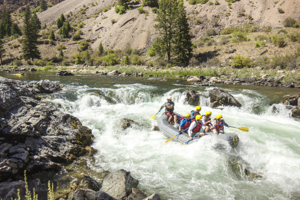 group of rafters rafting whitewater rapids at Middle Fork of the Salmon River in the summertime in Idaho, North America