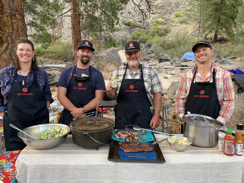 rafting guides and staff greeting group of travelers who are on a rafting trip to Idaho's Middle Fork of the Salmon River in North America